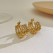 European and American retro light luxury high -level sense C -shaped semi -cyclical beaded titanium steel earrings temperament stainless steel earrings female